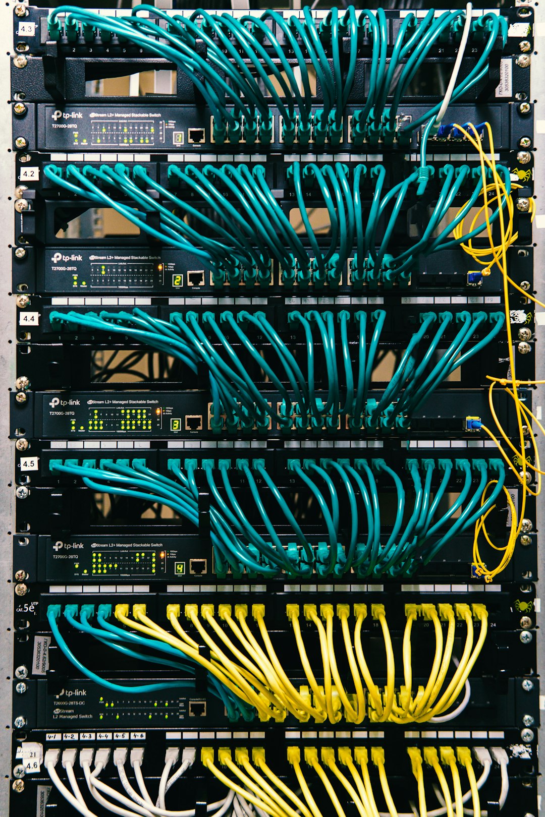 a-rack-of-servers-with-wires-and-wires-attached-to-them-c-lsqecd9oi